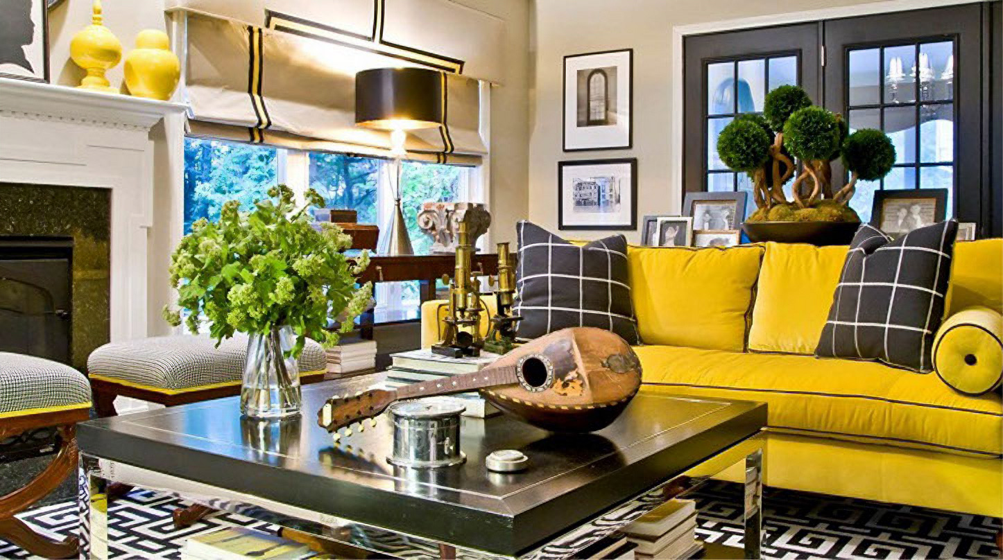Living room with a black-banded Roman shade behind a yellow sofa with checked cushions